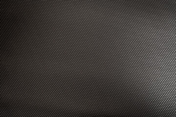 hexagonal metallic texture with light shining on it