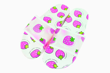 Rubber slippers with strawberry pattern white background.