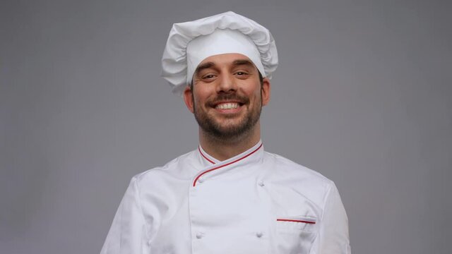 happy smiling male chef adjusting toque