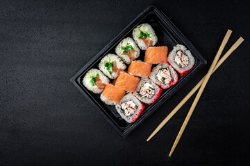 Sushi rolls on black background. Japanese food.