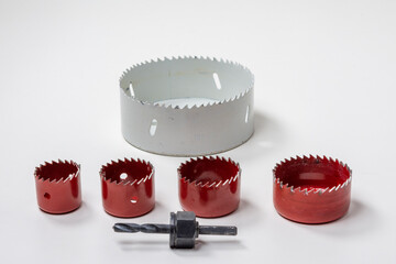 Hole saws of various sizes and pilot drill for them