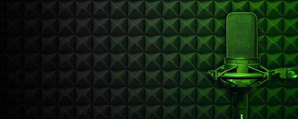 Professionnal recording studio microphone with green lighting on dark acoustic foam background, music or podcast production banner with copy space