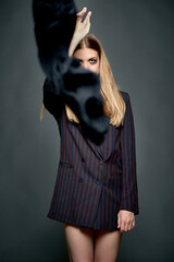 Studio photo of a blonde woman throwing a black foulard. Blonde woman throwing a black foulard