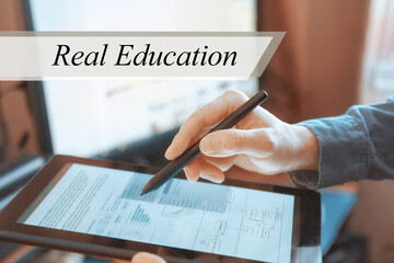 The tablet in the hands of a businessman. Real Education concept
