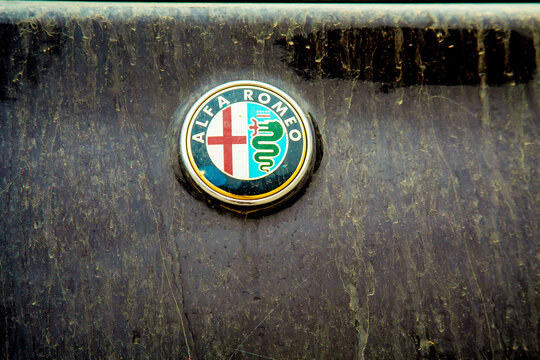Israel, Haifa,  - March 23, 2021: Dirty Alfa Romeo logo or emblem on a dirty black car because of a hamsin