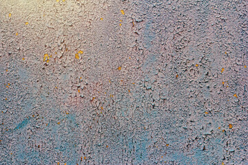 Old concrete wall covered with pastel pale colorful paint.