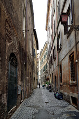 Fototapeta na wymiar narrow street in old city (downtown) - Rome, Italy
