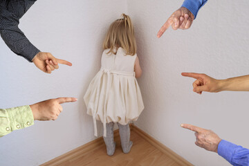 small child in a white dress, baby, a blonde girl stands in the corner of the room, hands of...