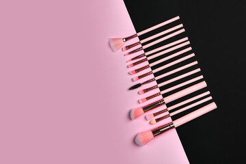 set of makeup brushes on a black and pink background