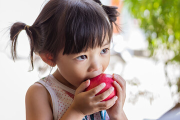 Portrait​ image​ of​ 2-3 yeas​ old​ of​ baby.​ Happy​ Asian child girl eating and...