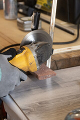 grinder worker cuts a stone the electric tool worker is tiling at home, brick