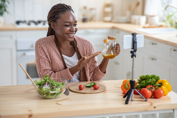 Culinary Vlog. Smiling Black Food Blogger Woman Recording Video Content In Kitchen