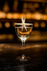 front view of beautiful glass with delicious alcoholic drink decorated with plant