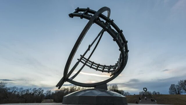 Bronze Sundial With The Wheel of Life Sculpture In Background At Sunset In Vigeland Park, Frogner Park, Oslo, Norway. - hyperlapse