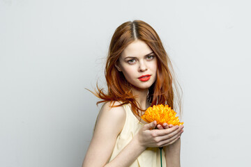 woman with yellow flower near face glamor studio