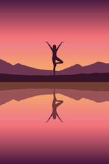 girl makes yoga by the lake at sunset