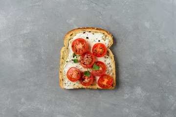 Healthy vegetarian sandwich with vegetables - cherry tomato. Cream cheese and microgreens