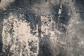 Rough texture with dark faded paint and a porous surface