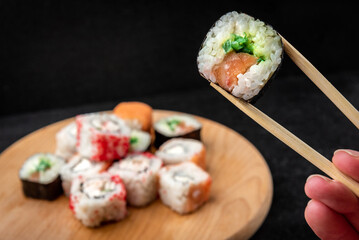 Sushi rolls on black background. Japanese food.