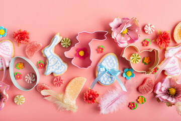 Easter frosted cookies in shape of egg chicken and rabbit, sugar sprinkles, candies, cookie cutters...