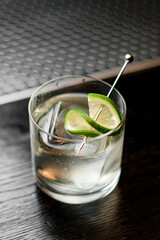 high angle view of glass with refreshing cold drink decorated with slice of lime