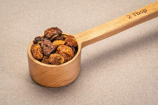 dried goldenberry berries in wooden measuring scoop (2 tablespoons), super fruit from Peru