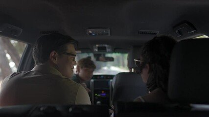 Happy Asian family in car having fun together with outdoor lifestyle activity on summer beach road trip vacation. Healthy senior man driving car with talking and looking to beautiful beach with family