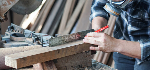 Banner of carpenter hand working on woodworking. measuring wood with ruler and pencil. men at work concept. copy space