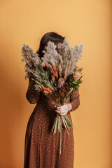 Bright trendy composition of dried flowers, home decor, a long-lasting gift of flowers and herbs