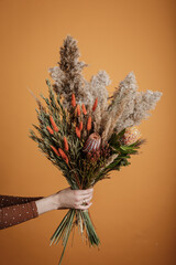 Bright trendy composition of dried flowers, home decor, a long-lasting gift of flowers and herbs