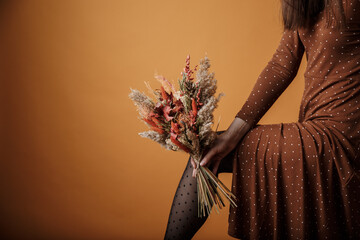 Bright trendy composition of dried flowers, home decor, a long-lasting gift of flowers and herbs