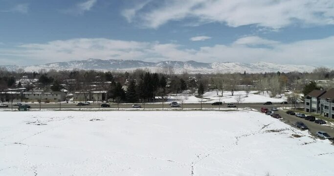 A wide pan shot of the rocky mountains from Fort Collins Colorado showing snowfall March 2021