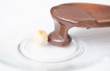 Hot melted chocolate pouring on the nut.