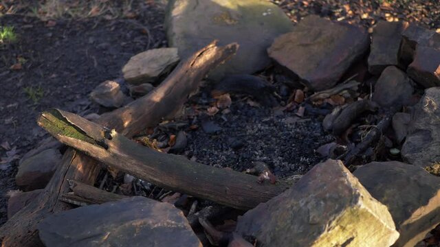 Burnt out remains of a camp fire