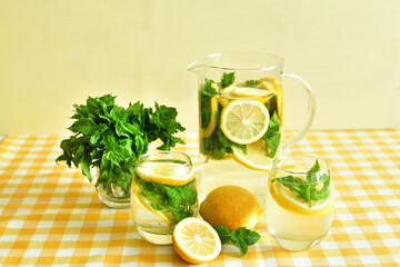 ripe fresh lemons, mint and lemonade sassy water. Vitamins concept. Strengthening immunity concept. Summer mood.color 2021