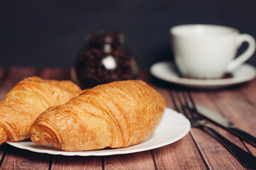 croissants white plates on the table kitchenware a cup of coffee meal dessert