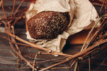 rye bread in a nest on a wooden table on a red background