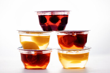 Bowls of colorful jelly, with pieces of fruits stacked in a pyramid. Side view. The concept of healthy desserts and home preservation