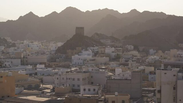 Old Watch Tower surrounded by Muscat Cityscape in Oman, Middle East - Wide static shot