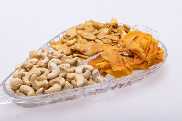 Roasted and salted fava beans, cashew nuts and dried mango slices for a healthy vegan and vegetarian diet snack. High in protein, vitamins, dietary fibre and nutrients