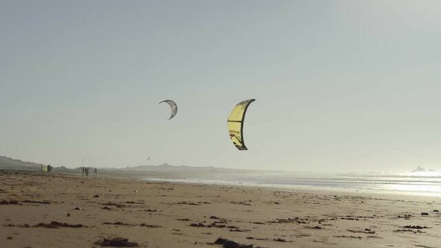 Kiteboarding activity in the waters of Morocco, Essaouira. Kiteboard, surfer, sea, ocean, waves, board, extreme sport, sportsman, summer, vacation / 4K Video Footage