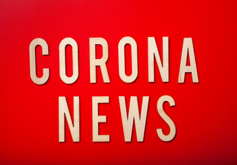 corona news word text wooden letter on red background corona virus covid-19