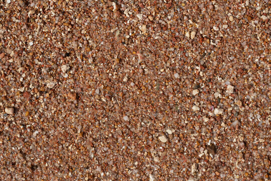 texture of small stones and sand. Background from beach pebbles. View from above. blank for text. High quality photo