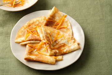 Crepes suzette with orange sauce and zest.