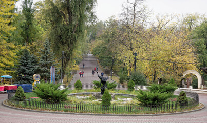 Pedestrians walk along Gorky Park in the autumn day