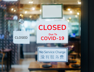  closed sign hanging outside a restaurant, store, office or other