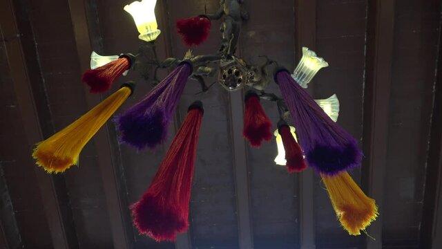 An old electrical lamp with colorful textile decoration, hang from the ceiling in a old asian hous in Penang city.