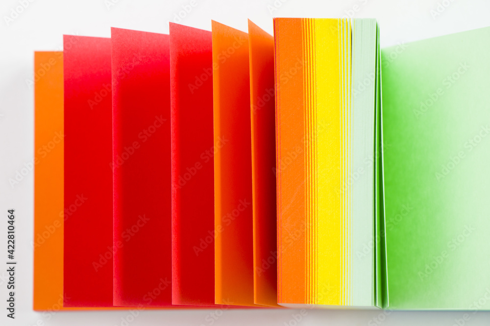 Poster overhead shot of a colorful notepad on a white surface