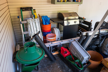 Household items stacked in the corner of a garage