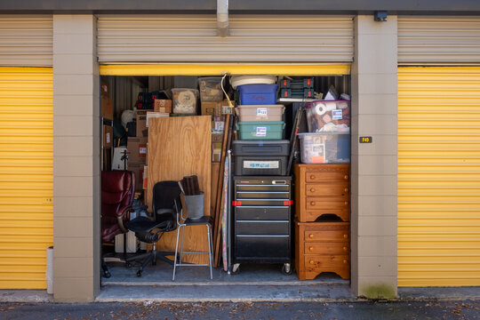 Contents of a house packed into a storage unit with the door open